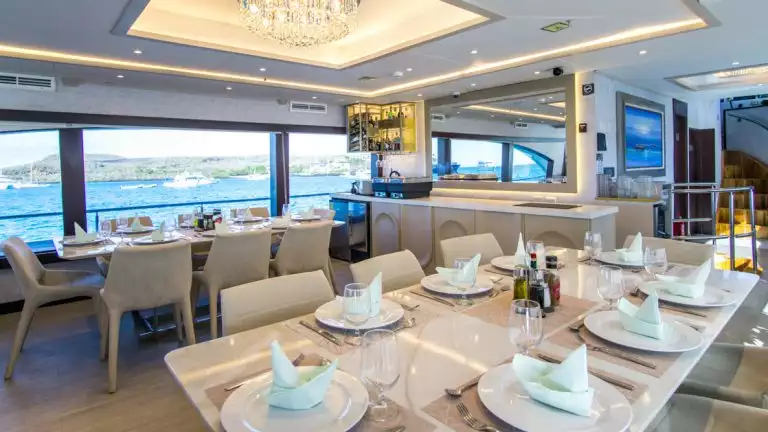 Dine in the beautiful dining room with sweeping views of the islands and waters while aboard the Grand Majestic in the Galapagos