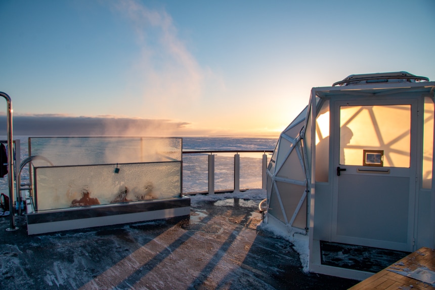 pastel sunset seen from the back of the observation deck with views of the on deck igloo and steaming hot infinity jacuzzi.