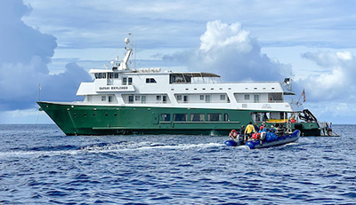 UnCruise reviews 36-guest Safari Explorer in Alaska with painted green hull and white upper decks. 