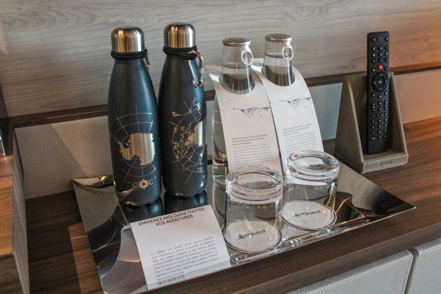 Black and gold stainless-steel water bottles given to guests in their cabin on day 1 of polar cruise aboard Charcot ship.