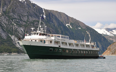 UnCruise reviews 60-guest Wilderness Adventurer in Alaska with painted green hull and white upper decks. 