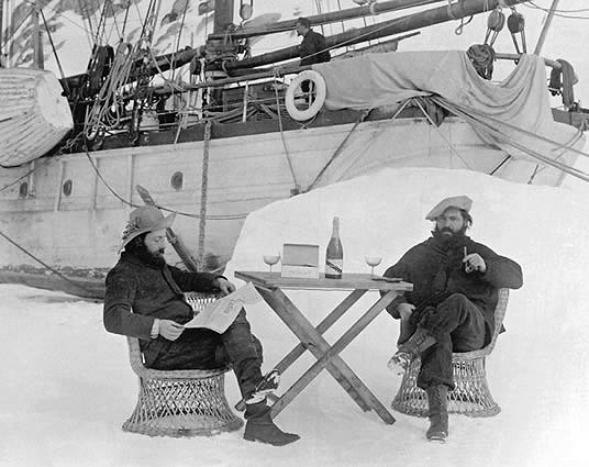 Famous black and white photo of jean-Baptiste Charcot drinking champagne in Antarctica in front of his ship Français