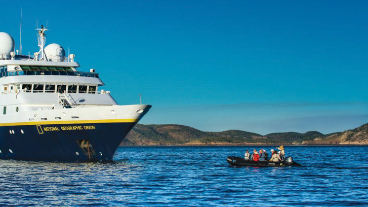National Geographic Orion boat with Zodiac of guests motoring towards it at Crocodile Creek, Kimberley Region, Australia.