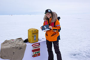 A traveler mails a postcard at the North Pole