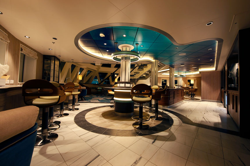 Science center aboard Sylvia Earle polar ship with marble tables, bar stools, large decorative lamps, windows and northern lights decorated ceiling.