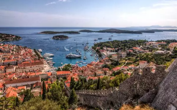 Croatia cruise port seen from above with red roofs and lots of ships anchored in the harbor