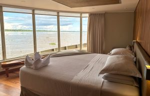 Panoramic windows from floor to ceiling give amazing amazon river view from the cabin aboard Delfin III.