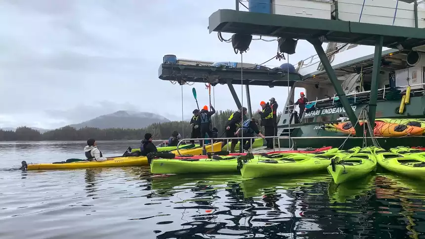 Green red and yellow kayaks are tied to the Safari Endeavour's high-tech kayak launching platform at the back of the ship.