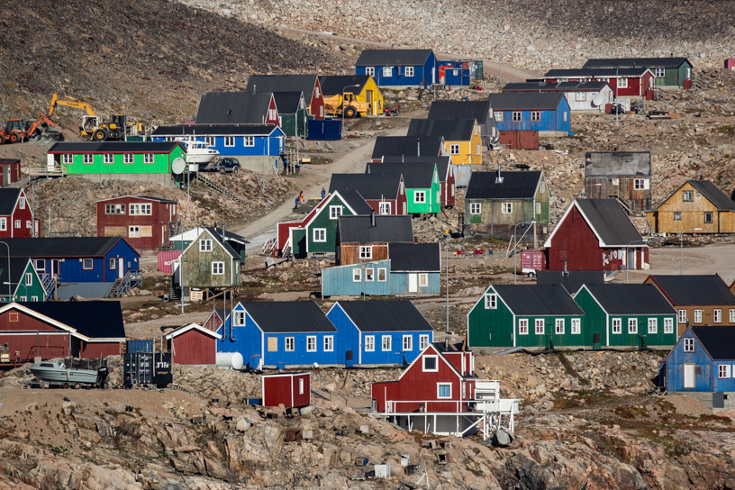 Bright and colorful green, blue, red, and yellow wood houses of the remote settlement of Ittoqqortoormiit in Greenland's Scoresby Sund. 