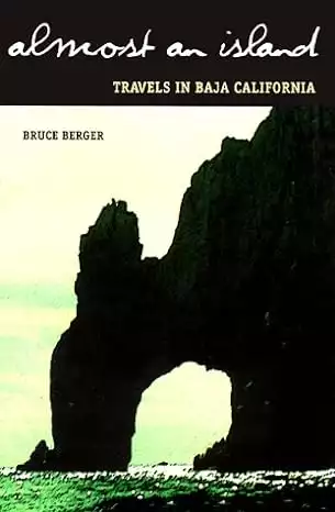 Book cover of Almost and Island by Bruce Berger showing a rock arch over green water in Baja. 