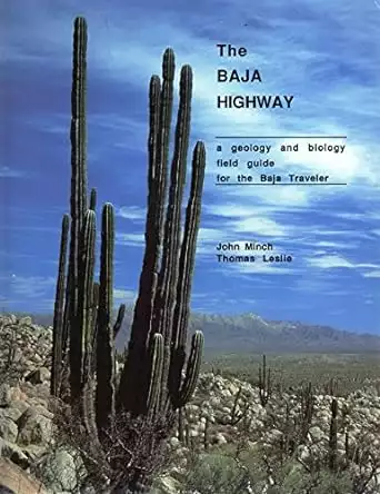 Book cover of the Baja Highway with a photograph of a desert landscape with a large green cactus and blue sky with white clouds.  