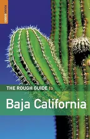 Book cover of the Rough Guide to Baja California by Jason Clampet with a closeup photograph of a large green cactus and blue sky in the background.  