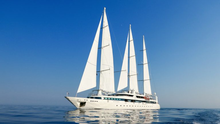 3-masted white motorsailer Le Ponant with 5 sails unfurled cruises calm seas on a sunny day of the Croatia Under Sail cruise.
