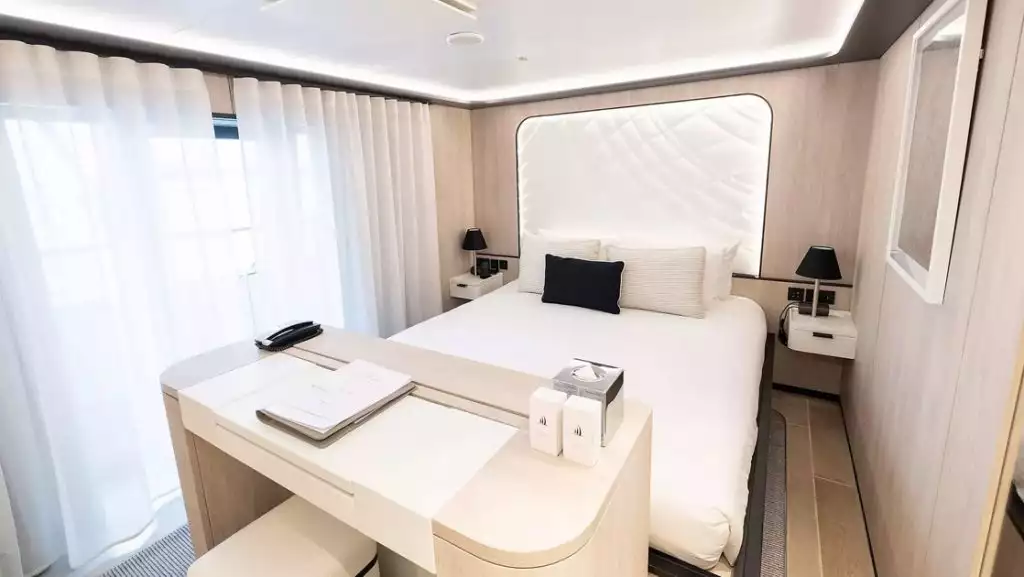 Alizes Prestige Stateroom with king bed aboard Le Ponant. Photo by: Ponant