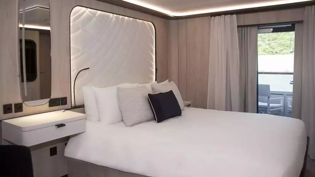 Second room of Grand Privilege Alizes Suite, with king bed, aboard Le Ponant. Photo by: Ponant
