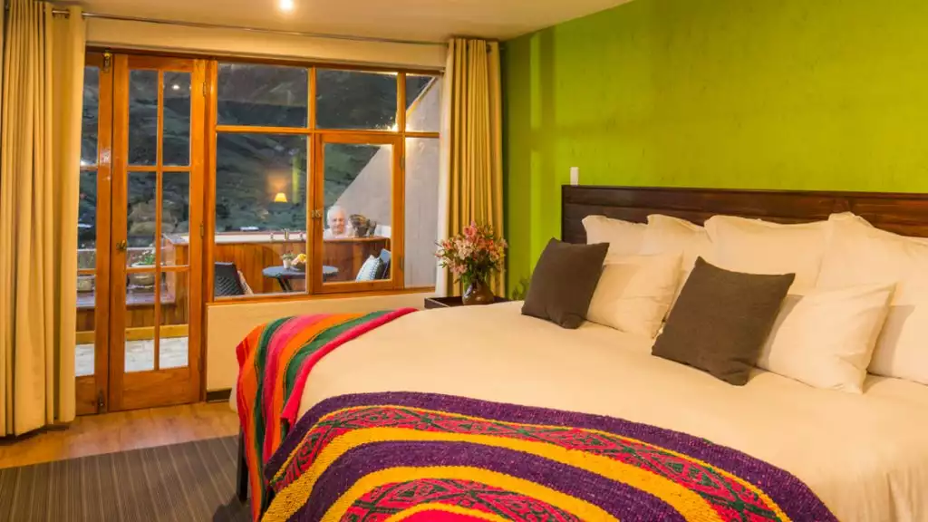 Guest room with a king bed at Huacahuasi Lodge