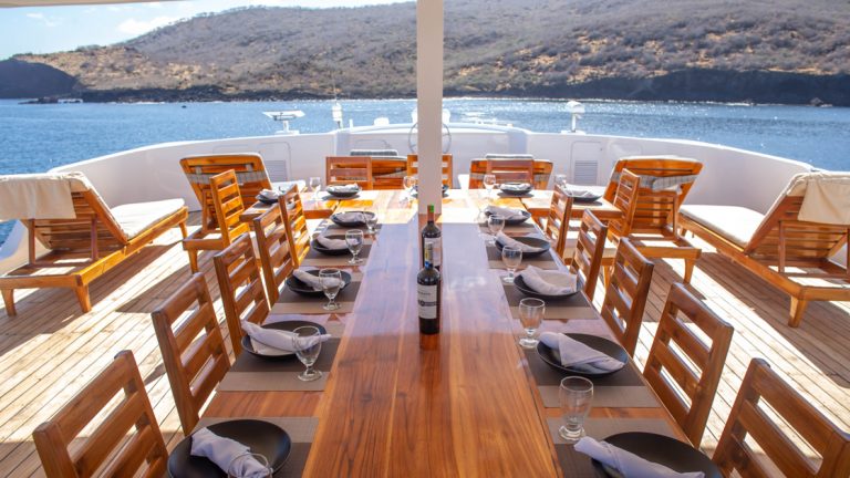 On the Sun Deck take a wondrous meal while taking in the magestic while aboard the Natural Paradise cruising in the Galapagos