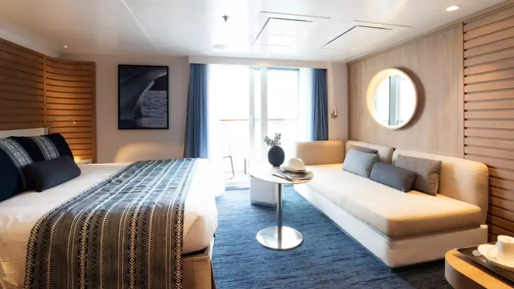 Deluxe Suite with king bed aboard Le Laperouse. Photo by: Ponant