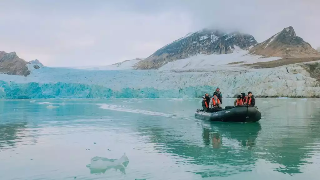 In North Spitsbergen we see a zodiac returning from an excursion to see a glacier