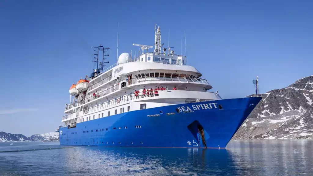 Exterior starboard side & bow of Sea Spirit polar expedition ship with blue hull & white upper decks.