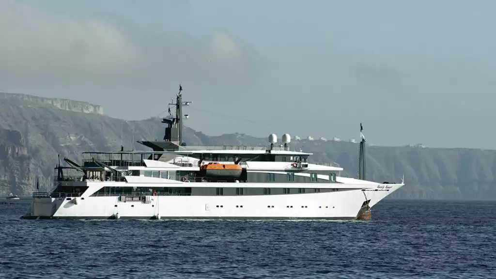 The white Variety Voyager Greece yacht seen sailing from its starboard side by the cliffs of Santorini
