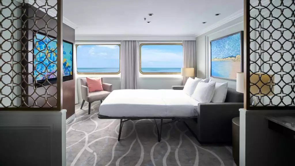 Islander Suite living room with fold-out couch for additional occupancy aboard National Geographic Islander II. Photo by: Marco Ricca
