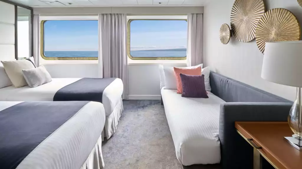 Suite with twin beds and sofa bed for triple occupancy aboard National Geographic Islander II. Photo by: Marco Ricca