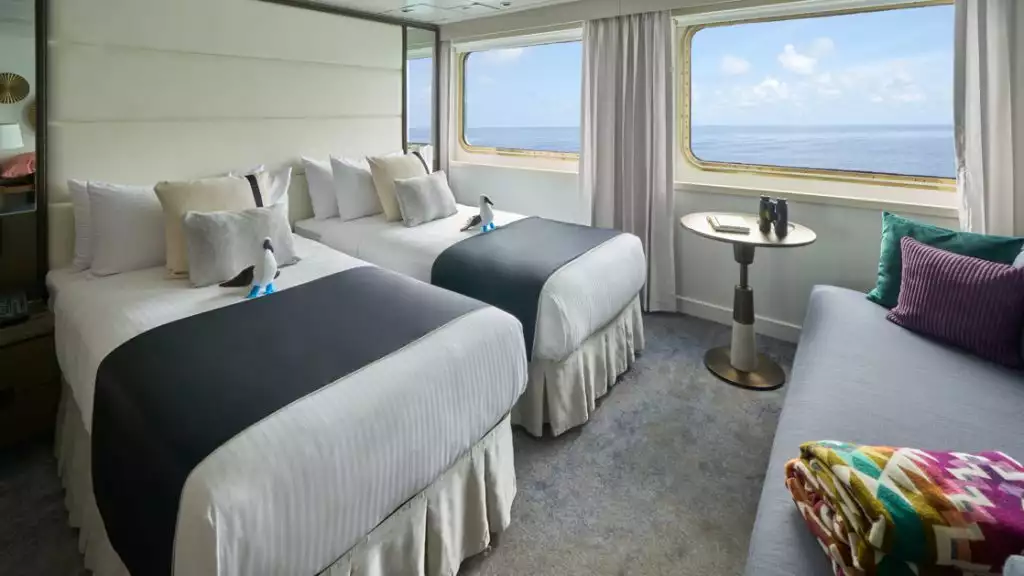 Suite with twin beds aboard National Geographic Islander II. Photo by: Marco Ricca