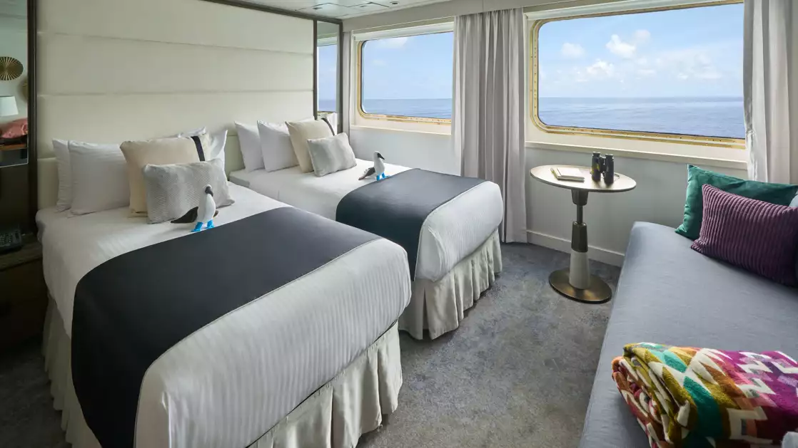 Suite with twin beds aboard National Geographic Islander II