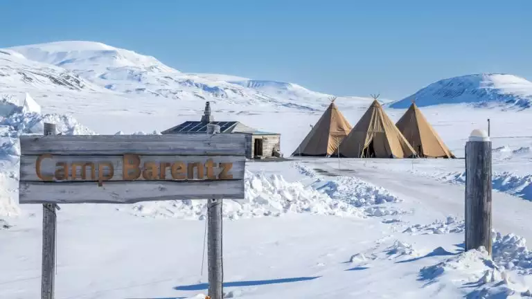 Camp Barentz with a backdrop of Snowy landscapes in the Artric during a landcruise