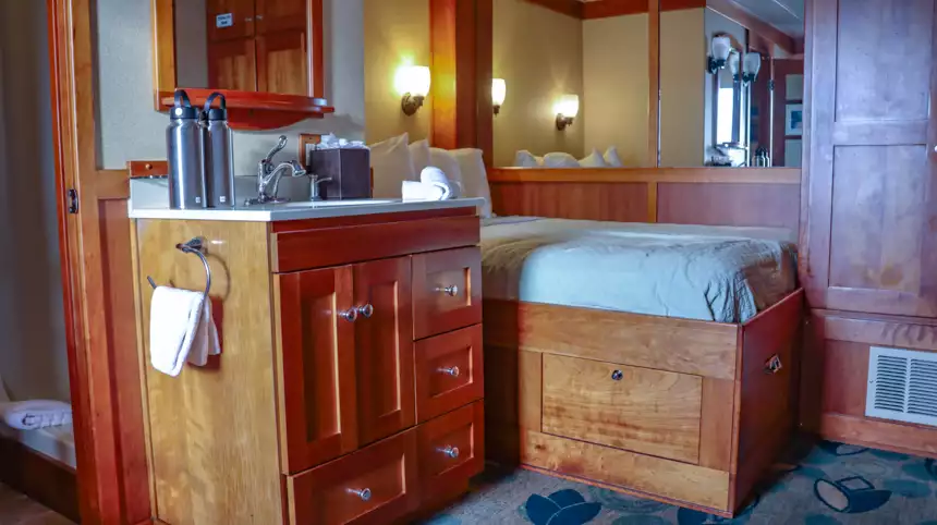 Small cruise bedroom with bathroom attached and brown wood 