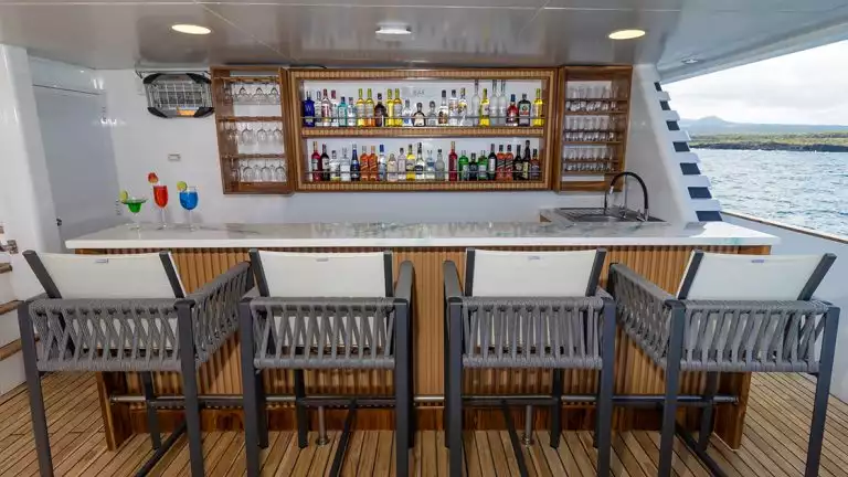 Four barstools at an outdoor bar aboard Galapagos Angel yacht