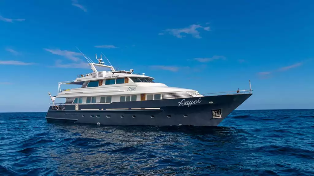 The blue-hulled Galapagos Angel yacht seen on its starboard side at sea