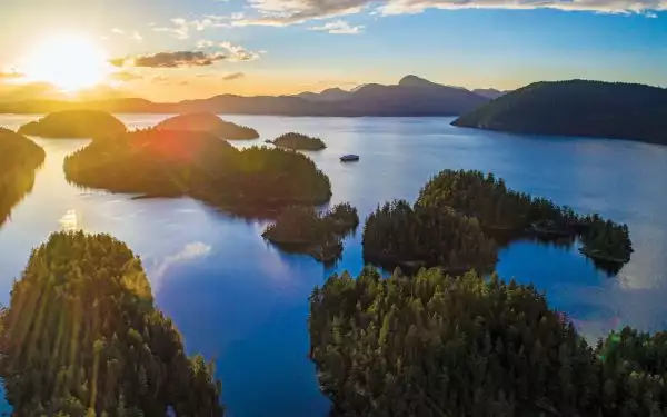 Aerial view of gumdrop green islands at sunset, seen on Canada small ship cruises.