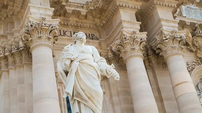 An old statue in a historical european style marble building