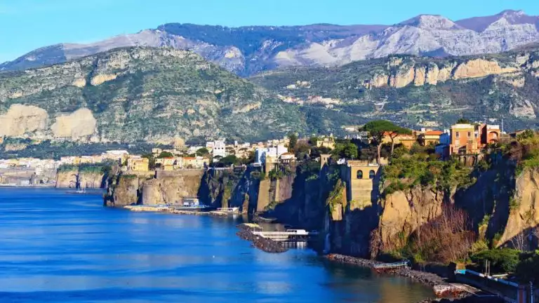 costal cliffs with rocky landscapes and green trees that line the coast almost as a wall