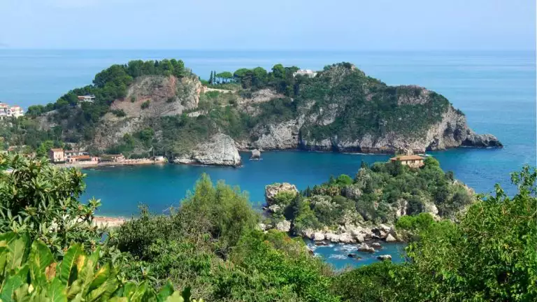 ariel view of costal islands with green trees and rocky landscapes over blue teal water