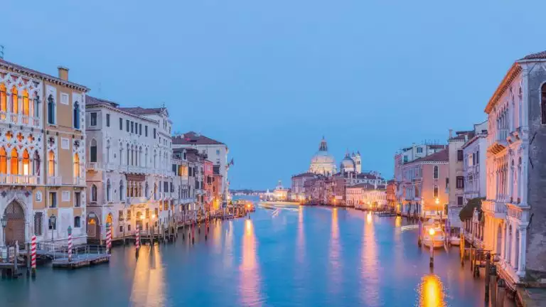 evening in the canals of Venice with beautiful historic buildings and light reflecting off the calm water of the canal