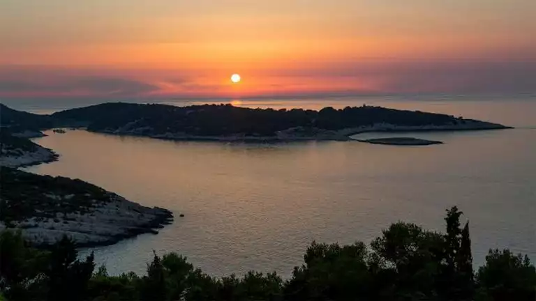 ariel view of orange and yellow sunset over Adriatic sea on a calm day