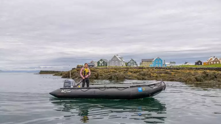 Lindblad staff member skillfully navigate a Zodiac boat around the scenic waters of Flatey Island, Breiðafjörður, Iceland.