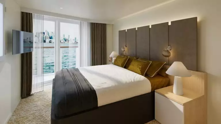 Pearl Suite of Paspaley Pearl ship with double bed in white & black linens & dark headboard, private balcony, TV & light accents.