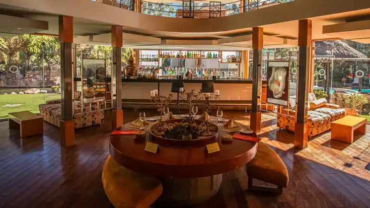 Bar inside of hotel with 360 views and glass walls surrounding the modern and eclectic bar with a wood style