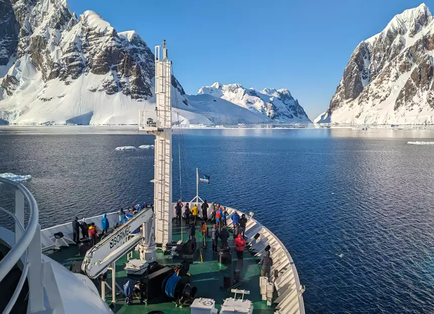 Beautiful view off small expedition ship  looking out into the snowy rocky mountains of Antarctica 
