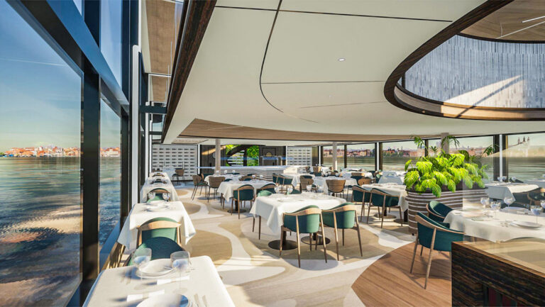 Dining room aboard MY National Geographic Connect with tables of various sizes set for dinner in white linens by glass walls.