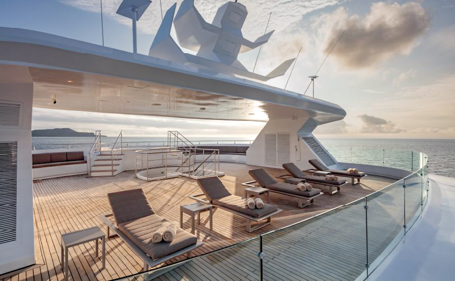 The Sun Deck aboard Hermes showing five lounge chairs with rolled towels on them.